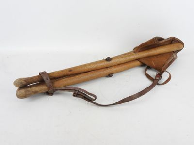 an old pair of wooden sticks sitting on top of a white surface