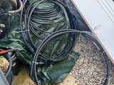 a pile of hoses and other items on the ground
