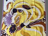 an image of a yellow and purple scarf with a woman ' s face on it