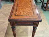 an image of a small table with a wooden top on a wooden floor