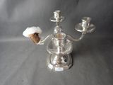 a silver candelab with two candles on top of it
