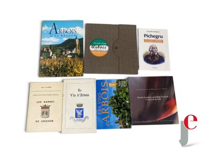 many books that are sitting on a white surface