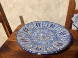 a blue and white plate sitting on a wooden table