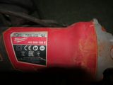 a close up of a drill with a red handle