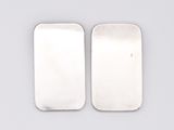 a pair of silver plated rectangulars on a white surface
