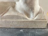 a statue of a man that is sitting on a table