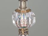 a glass perfume bottle with a gold decoration on it