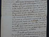un vieux papier sur lequel il y a des inscriptions, posé sur une table