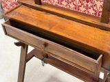 a wooden desk with a drawer on top of it