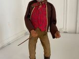 a figurine of a man wearing a cowboy hat and holding a stick