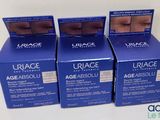 three boxes of urage age absolut eye creams on a table