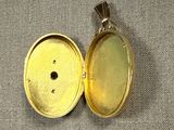 a close up of a gold locke with a small hole in it