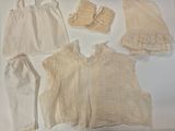four pieces of clothing on a white surface