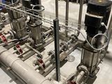 pipes and valves in a large room with a blue wall