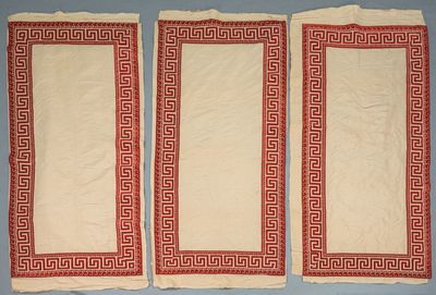 two red and white towels with greek designs on them