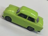 a green toy car that is sitting on a table
