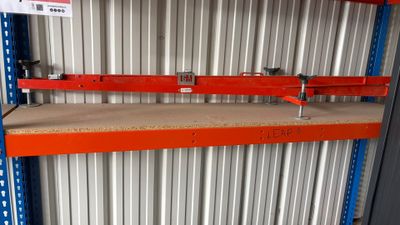 a close up of a shelf in a warehouse with a sign on it