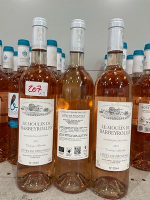 several bottles of wine are lined up on a counter