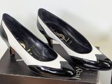 pair of black and white shoes sitting on top of a box