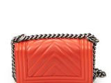 a small red leather bag with a chain strap