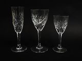 three empty wine glasses sitting next to each other on a black surface