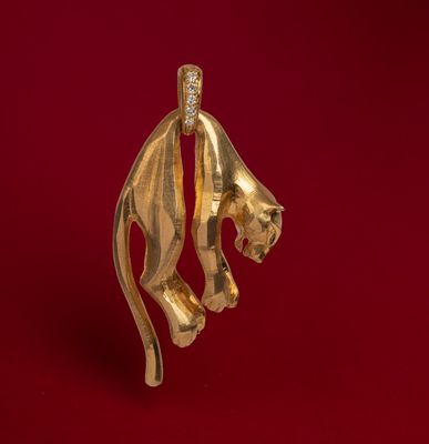 a close up of a gold lion head on a red background