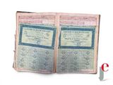 an old book with two pages of paper on top of it