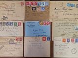 several old envelopes with stamps on them sitting on a table
