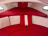 a view of a red and white boat with a red bed