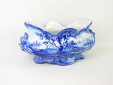 a blue and white bowl on a white surface