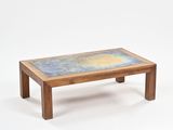 a small wooden table with a blue and yellow design on it
