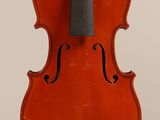 an old violin with a bow hanging from it ' s back