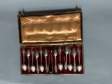 six spoons in a box on a table