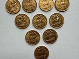 a bunch of gold coins sitting on top of a white surface
