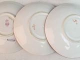 three plates are lined up on a wall with a white background