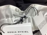 a close up of a black and white jacket with a tag on it