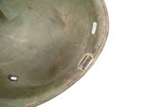 a close up of a green helmet with holes in it