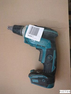 un gros plan d'une perceuse sans fil posée sur une boîte en carton
