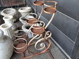 de nombreux pots et vases posés par terre à l'extérieur d'un bâtiment