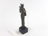 statue d'une femme tenant un panier, posée sur un socle en marbre