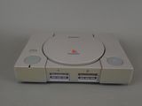 an image of a sony playstation game system sitting on top of a table