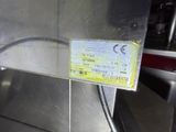 a ticket that is attached to a machine in a kitchen