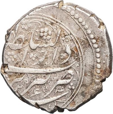 a silver coin with an image of a man on it