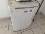 a white refrigerator with a toaster on top of it
