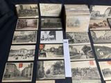 several old postcards of different types and sizes are on a table