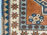 an old rug with a blue and brown design on it