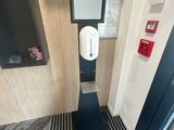 a bathroom with a toilet and a mirror on the wall