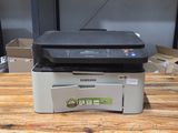 a printer sitting on top of a box on a wooden table
