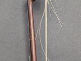 a wooden stick with a long string attached to it