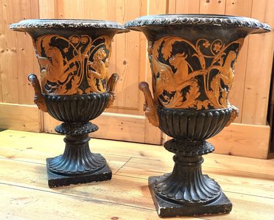 two vases sitting on a wooden table next to each other